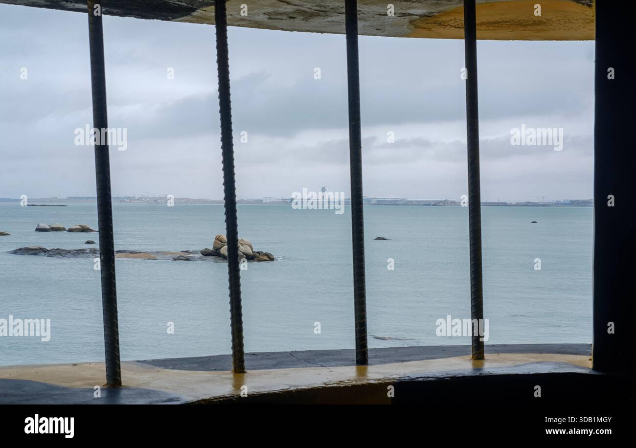 Looking through the bars of a coastal defense bunker in Kinmen towards ...