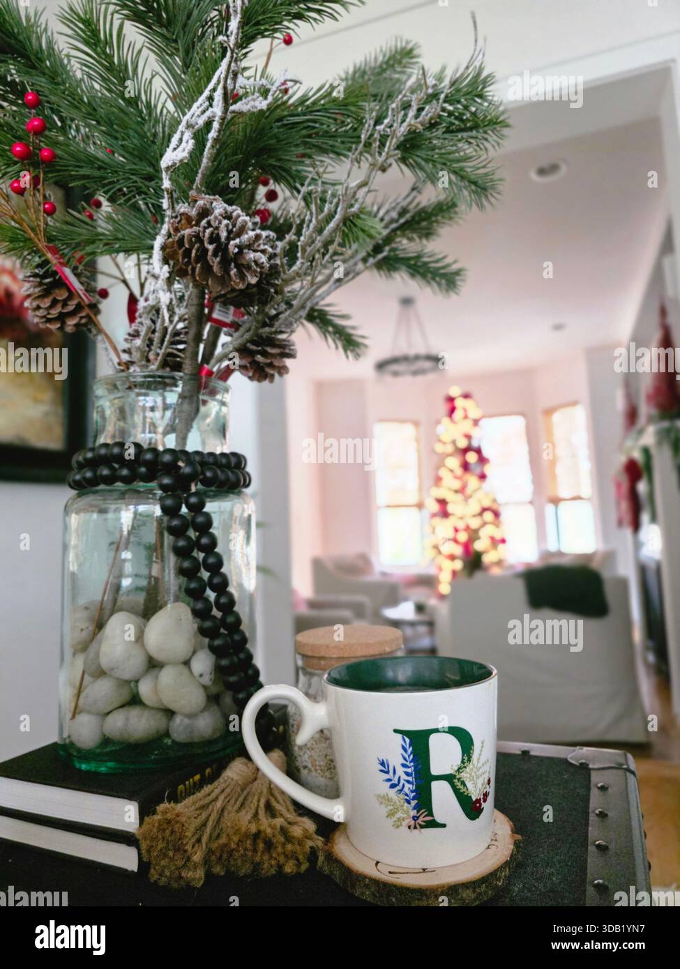 Holiday decorations in a cozy living room with a Christmas tree and a mug on a table - Smartphone Captured Stock Image