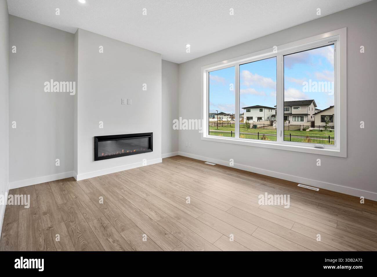 Large, empty living room with a fireplace and a window. The room is very  clean and has a very open feel to it Stock Photo - Alamy, image size:1300x956