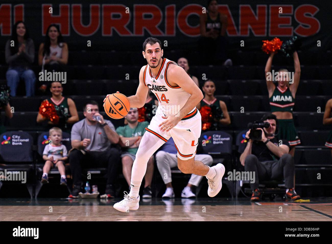 CORAL GABLES, FL - DECEMBER 13: Miami guard Noam Dovrat (14) brings the ...
