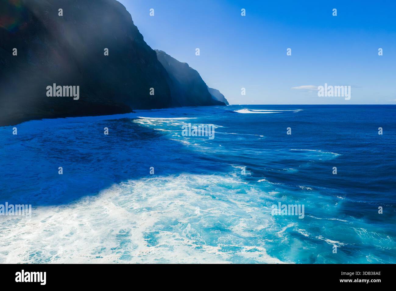 Madeira basalt cliffs meet vivid Atlantic surf near Porto Moniz Stock Photo