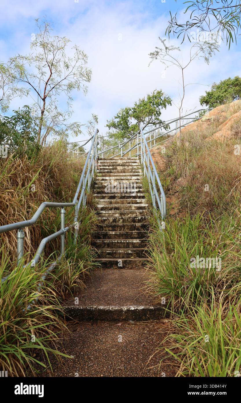Outdoor concrete stairs steps going uphill with metal railings on both ...