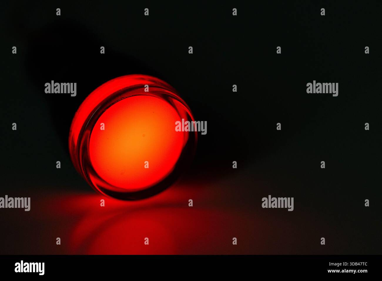 Red LED Indicator Light Isolated on Dark Background Stock Photo