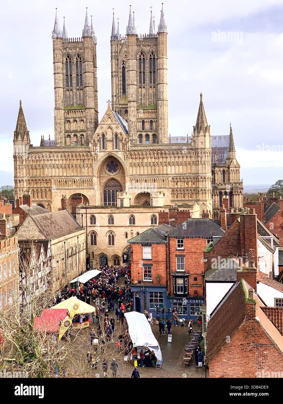 Lincoln Cathedral and street scene people singing in the rock Choir with Christmas hats happy Cultural tourism cityscape heritage site architectural - Smartphone Captured Stock Image
