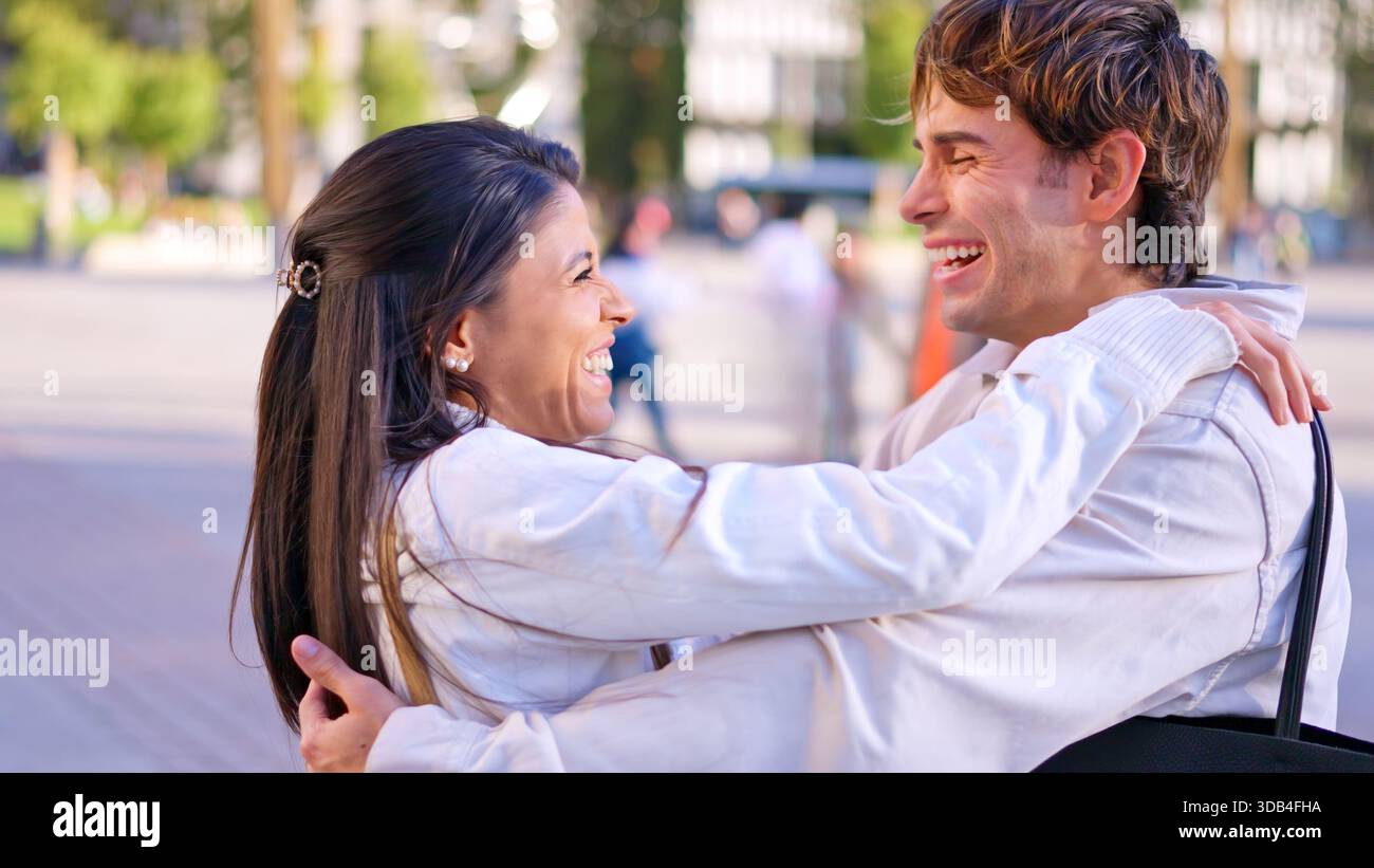 Happy diverse couple embracing outdoors enjoying inclusion Stock Photo