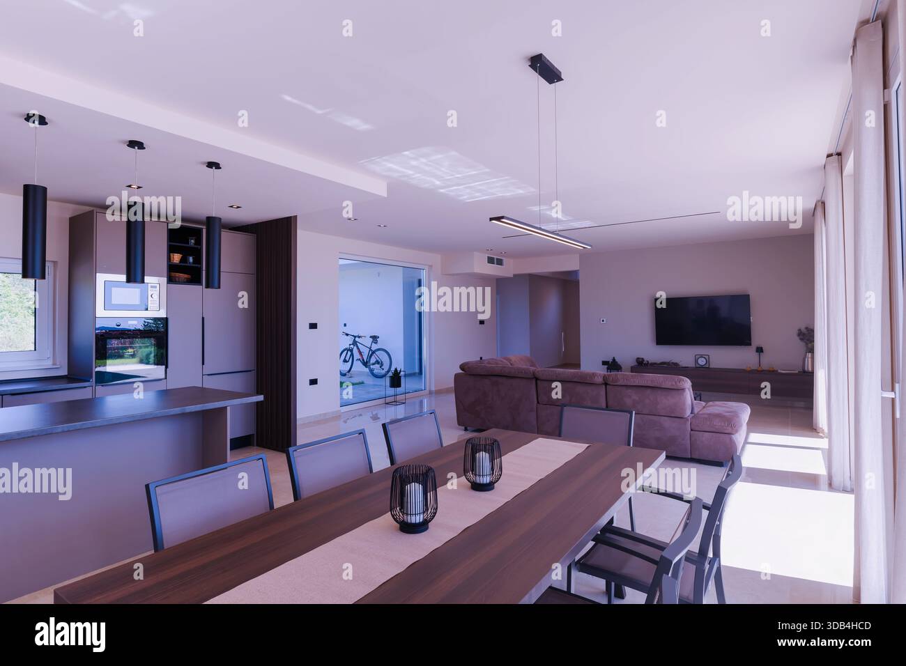 Modern open-plan living and dining room in a luxury villa with large ...