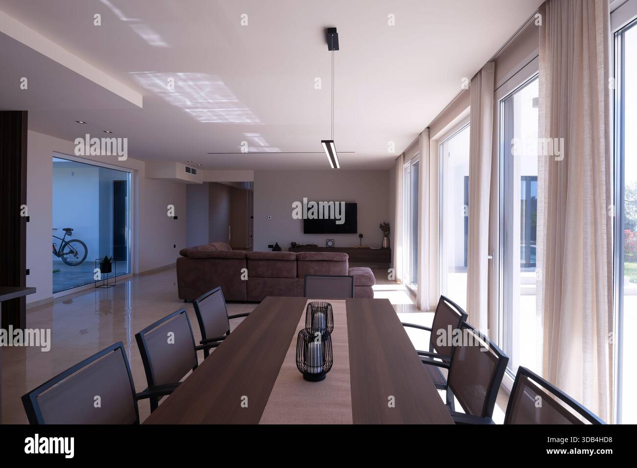 Modern open-plan living and dining room in a luxury villa with large ...