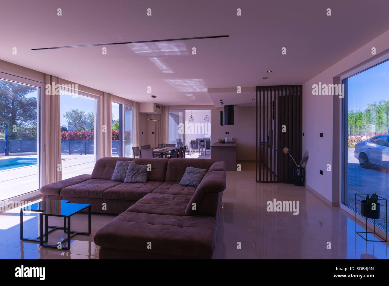 Modern open-plan living and dining room in a luxury villa with large ...