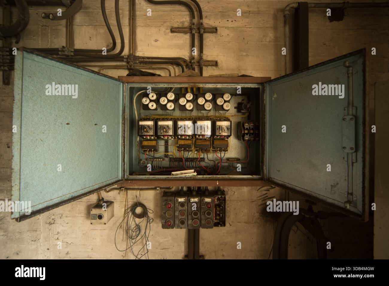 Open vintage electrical control panel in abandoned paper mill Stock Photo