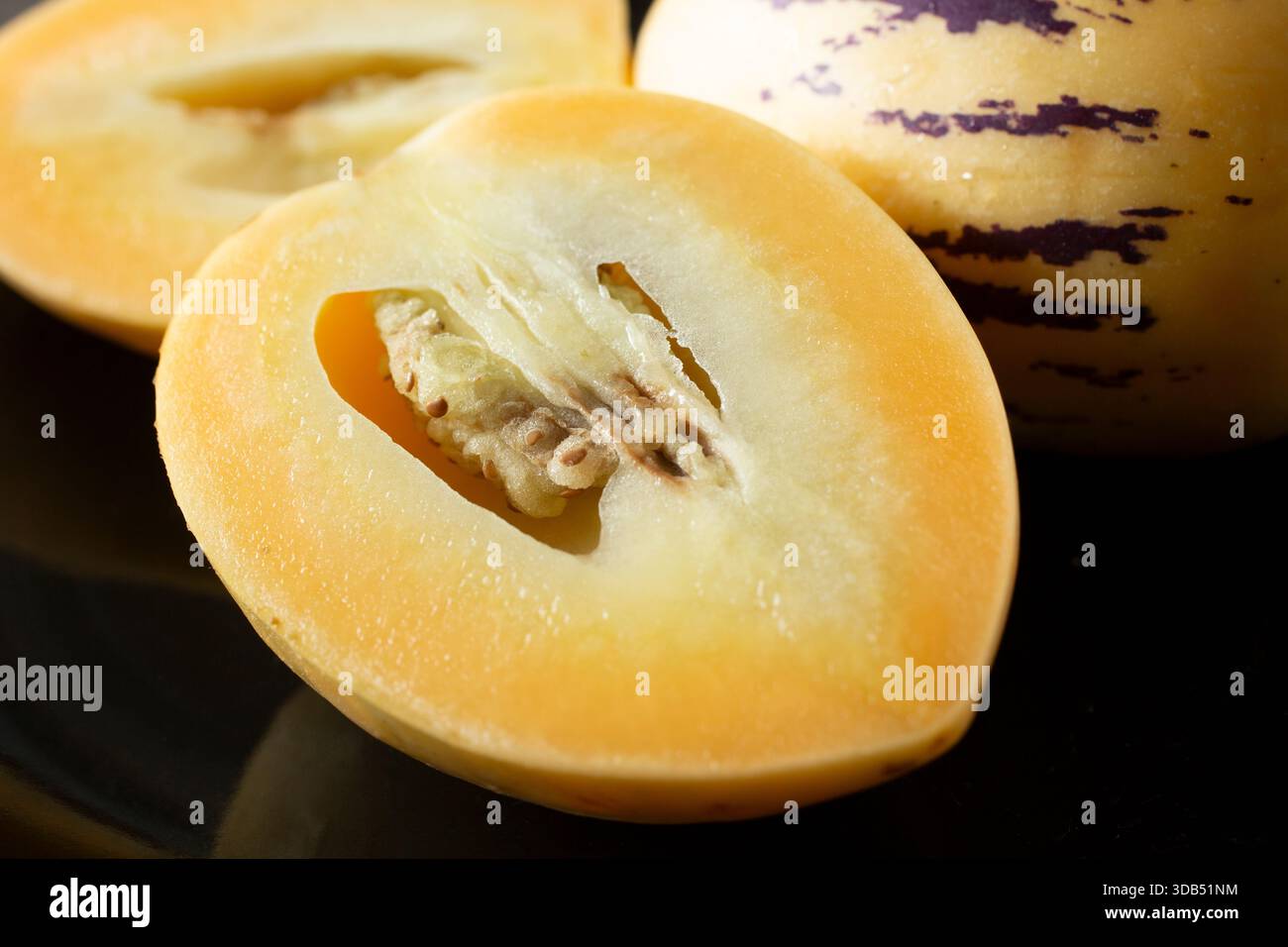 A closeup view of a halved pepino melon. Stock Photo