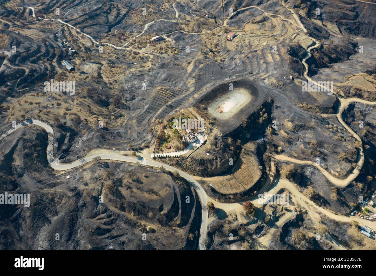Parched ground shows the aftermath of a devastating wildfire that swept ...