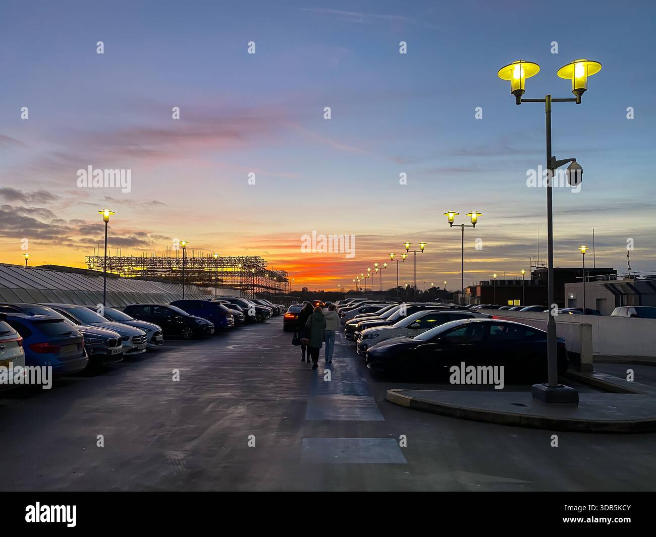 An orange sky at sunset seen from the top level of a multi storey car park in Reading, UK - Smartphone Captured Stock Image