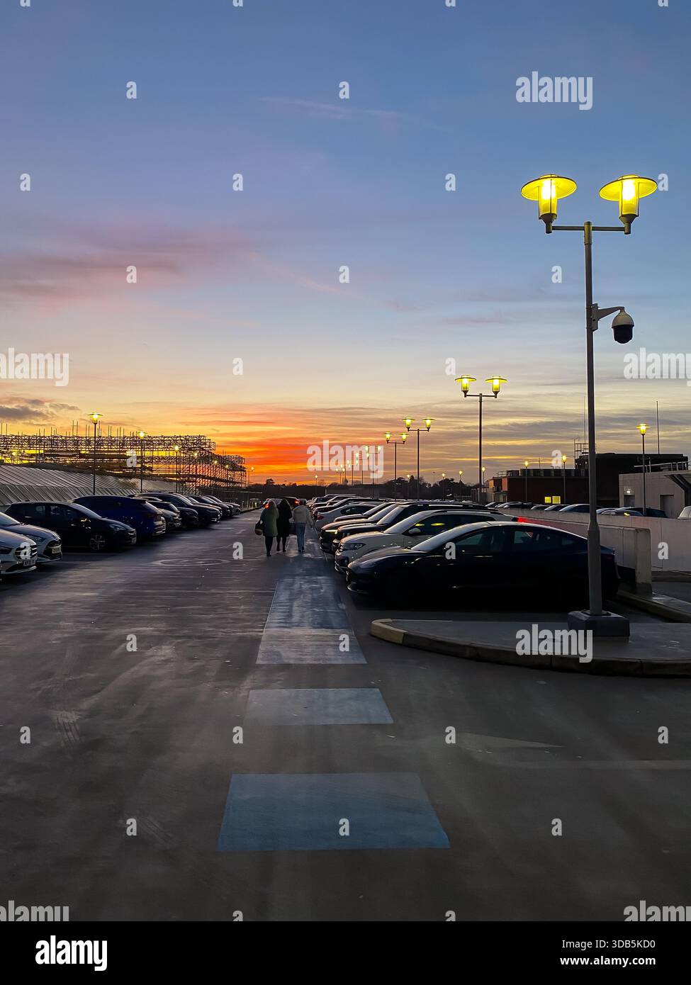 An orange sky at sunset seen from the top level of a multi storey car park in Reading, UK - Smartphone Captured Stock Image