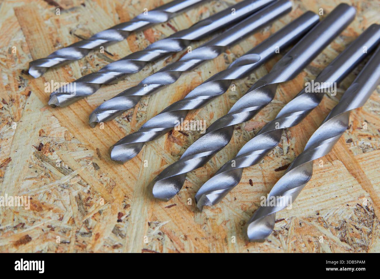 set of drills on metal on wooden background Stock Photo