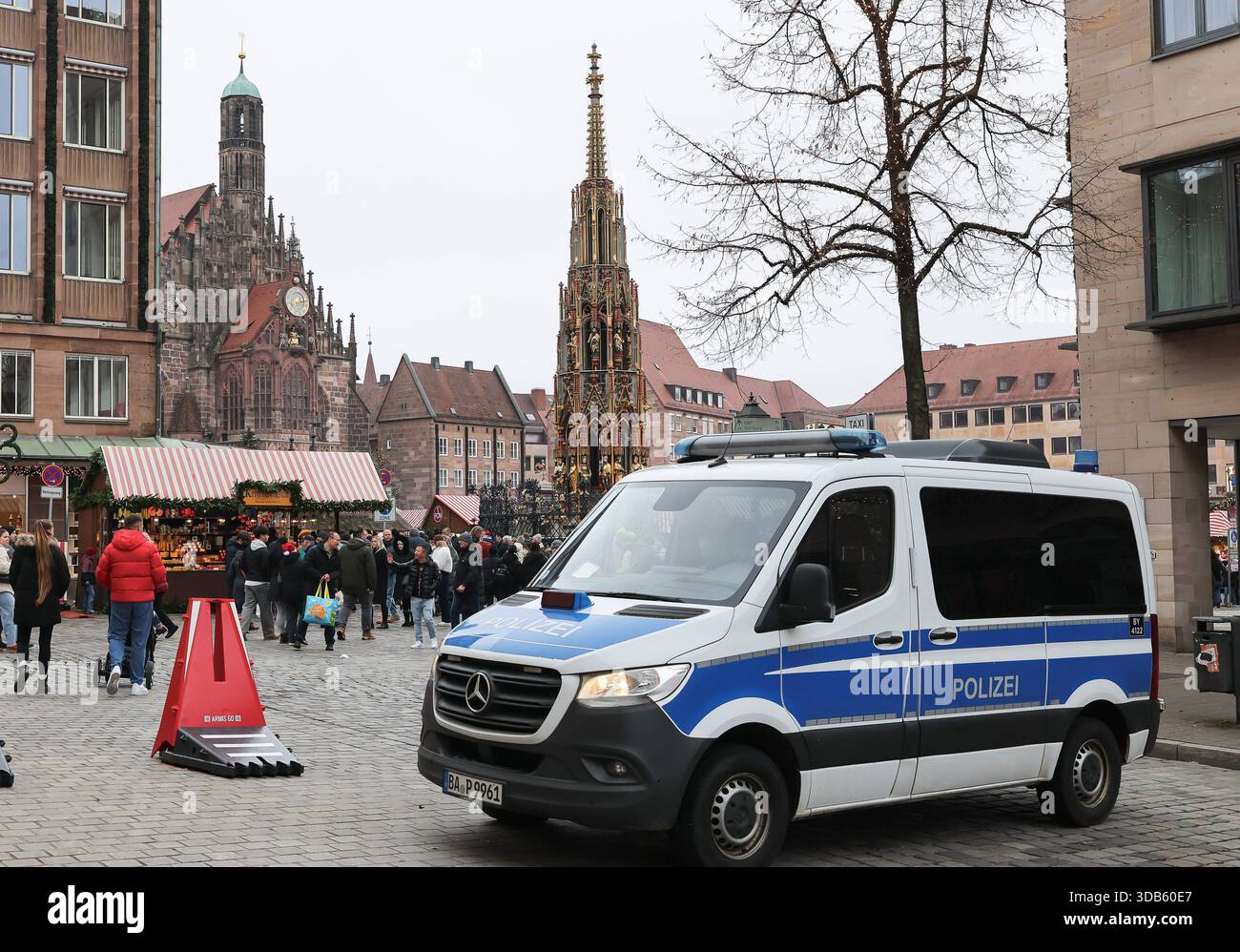 14 December 2025, Bavaria, Nuremberg: Bollards and a riot police team ...