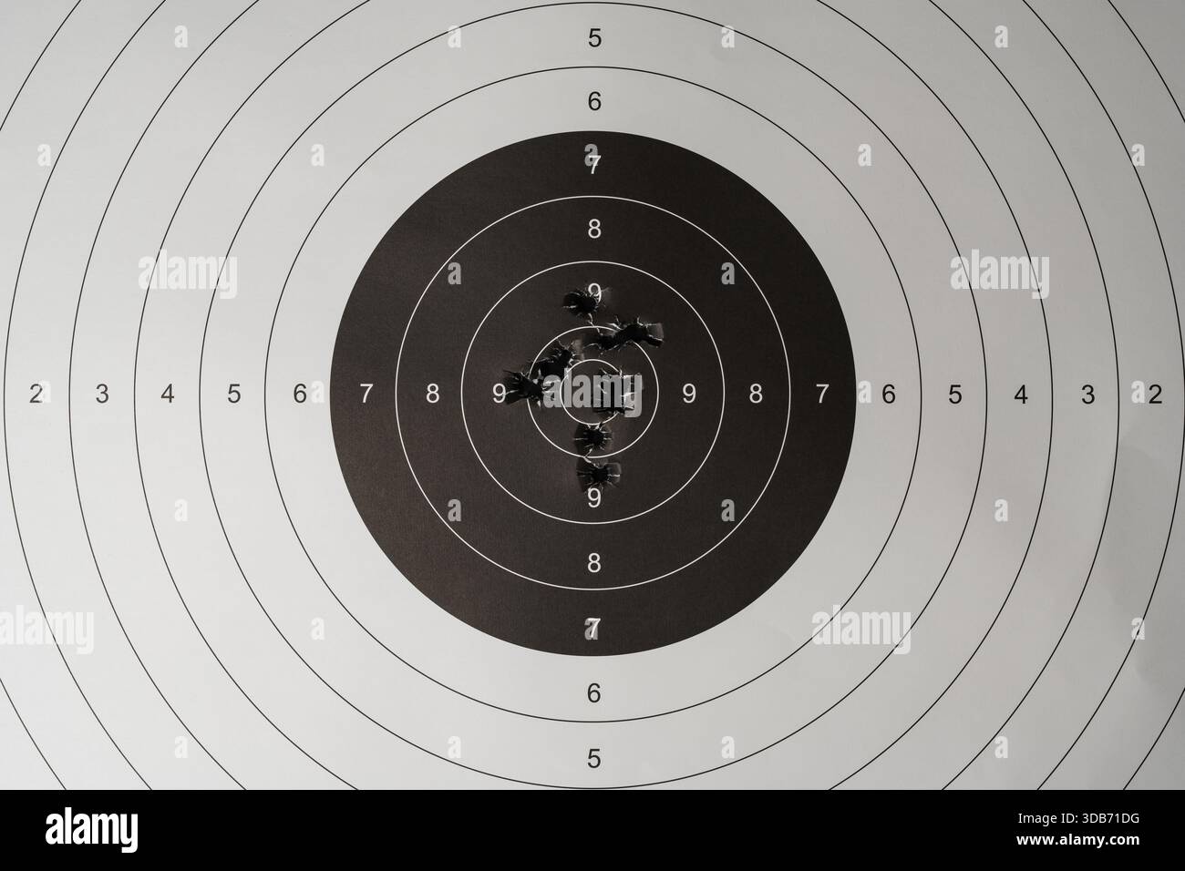 Precision shooting target practice showing a tight grouping of bullet ...