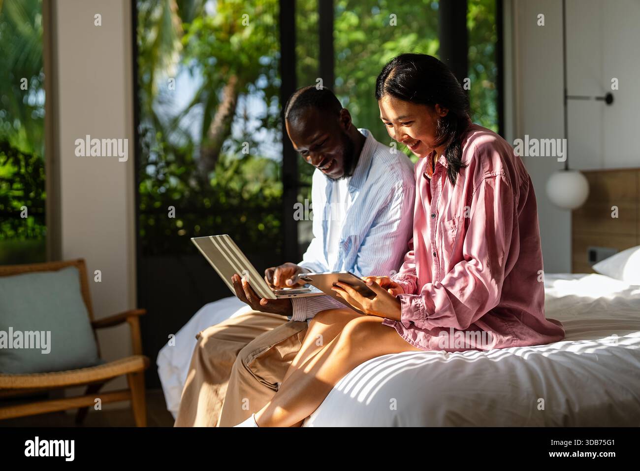 Couple of freelance IT specialists using digital technology devices while working remotely from home Stock Photo