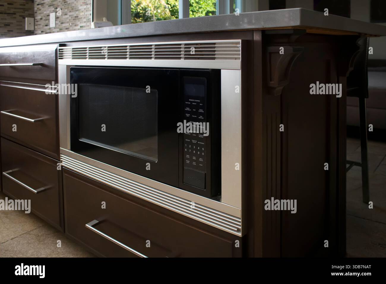 A view of a built-in microwave appliance in a kitchen setting. Stock Photo