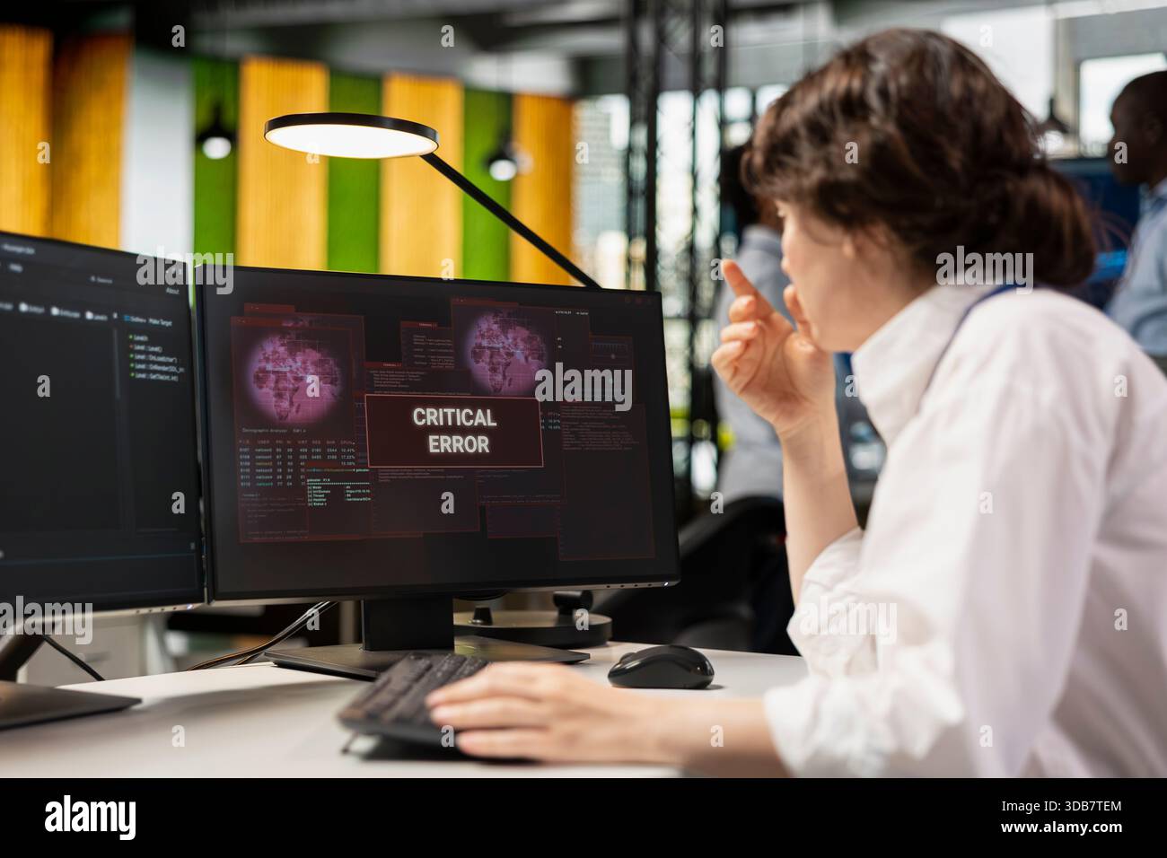 Startup office software developer doing debugging on PC, fixing malfunctions. IT professional at work repairing coding mistakes using computer monitor, doing quality assurance Stock Photo