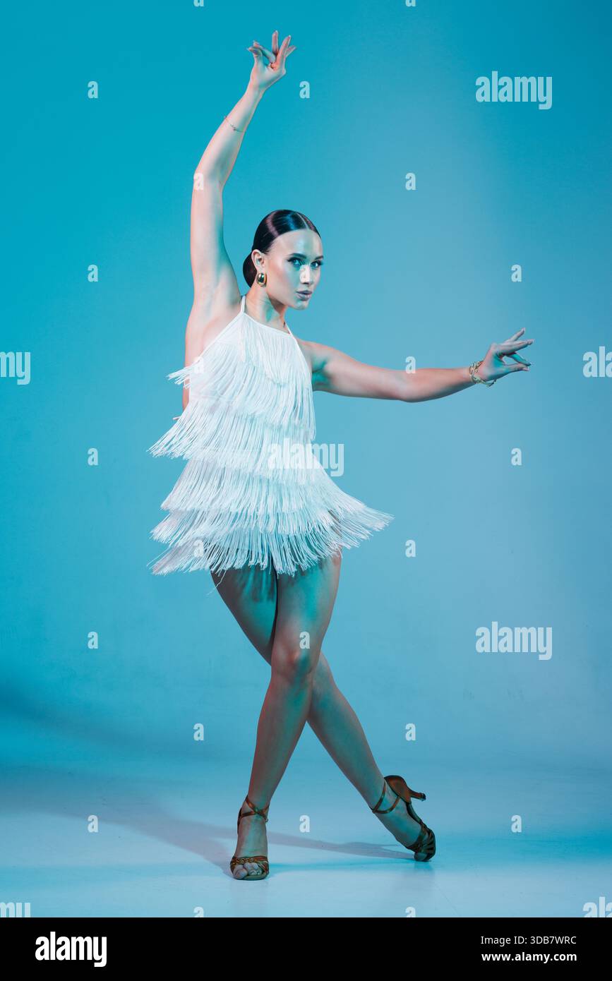 Elegant dancer in fringed dress dancing solo salsa dance showing dramatic pose under artistic lighting Stock Photo - Alamy Elegant dancer in fringed dress dancing solo salsa dance showing dramatic pose under artistic lighting Stock Photo - Alamy