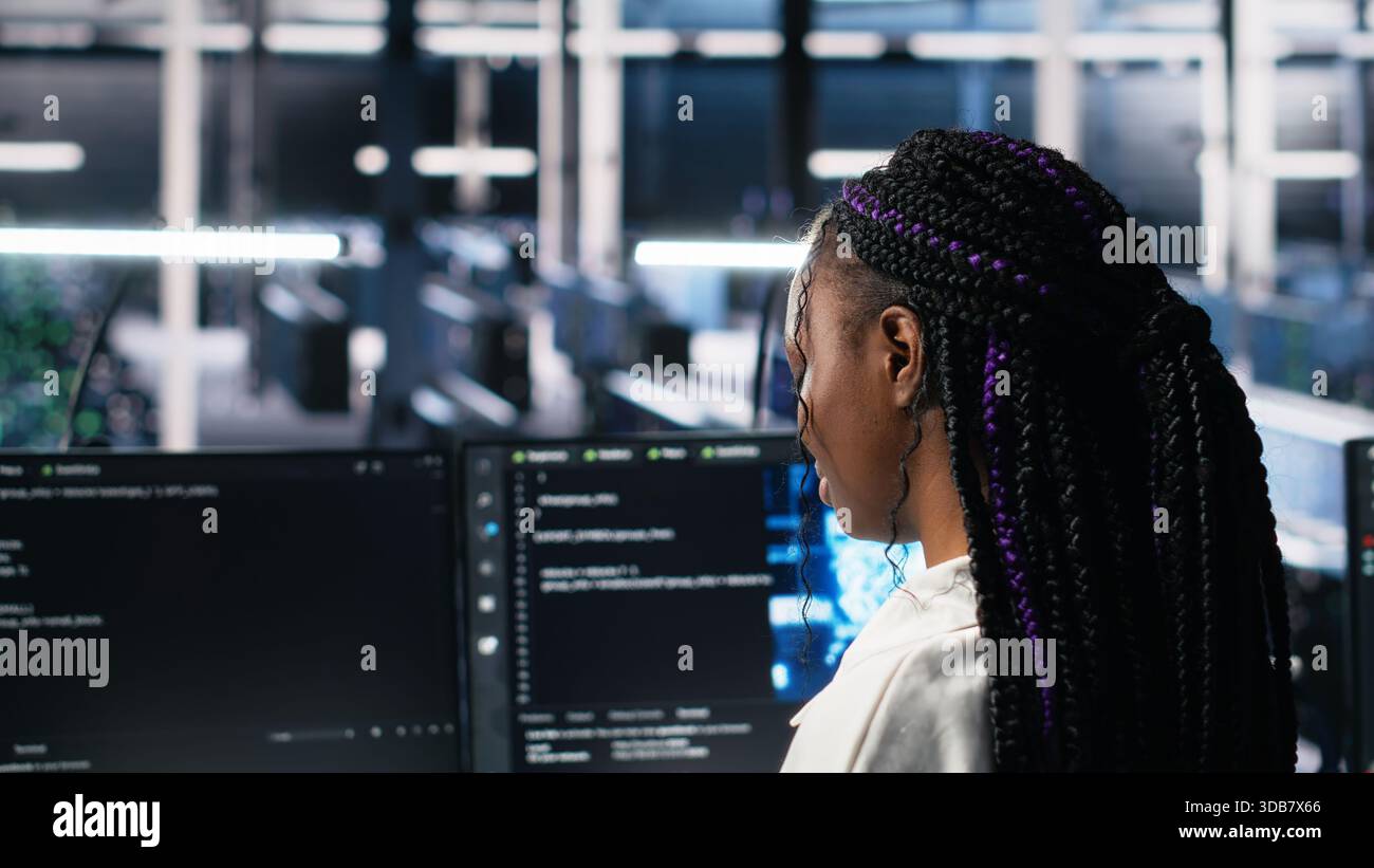 Technicians in data center review AI diagnostics, analyzing neural network performance to maintain operational reliability. IT workers optimize artificial intelligence systems configuration, camera A Stock Photo
