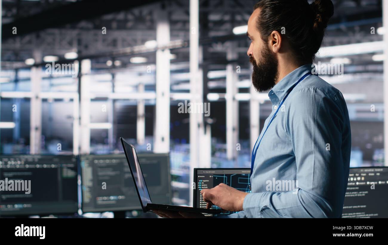 Server hub admin using AI LLM chatbot to review hardware diagnostics. IT expert in data center using artificial intelligence large language model to analyze performance data, handheld camera shot Stock Photo