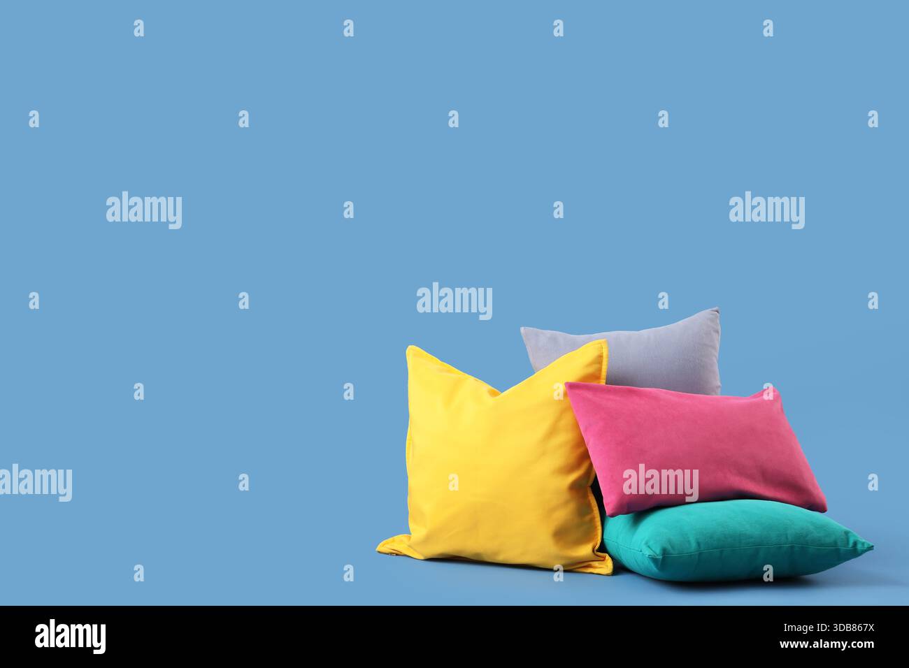 Different colorful pillows on blue background Stock Photo