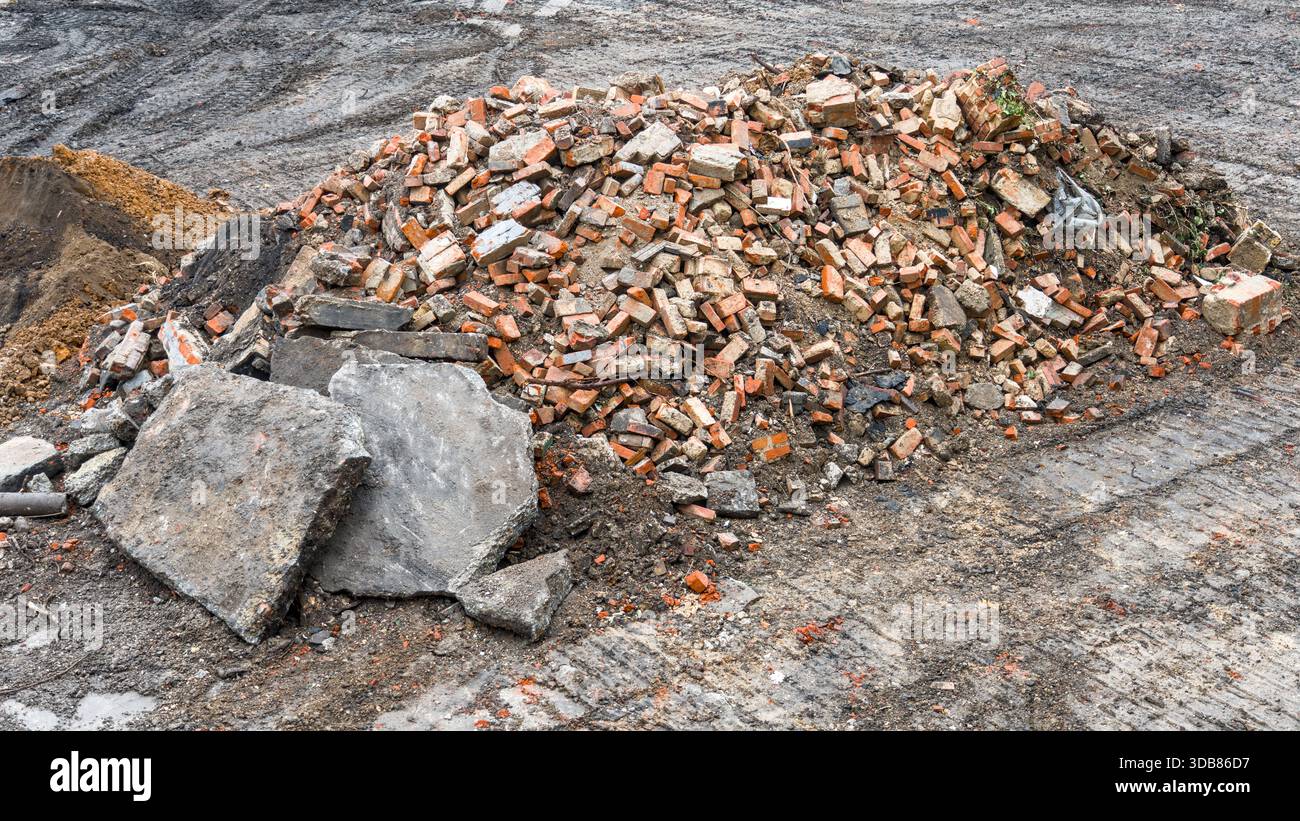 A large pile of crushed bricks and concrete slabs on a demolition site ...