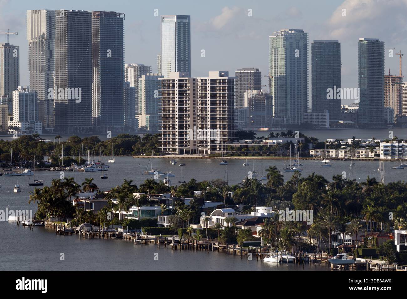 The Miami skyline rises beyond Biscayne Bay, with palm-lined causeways ...