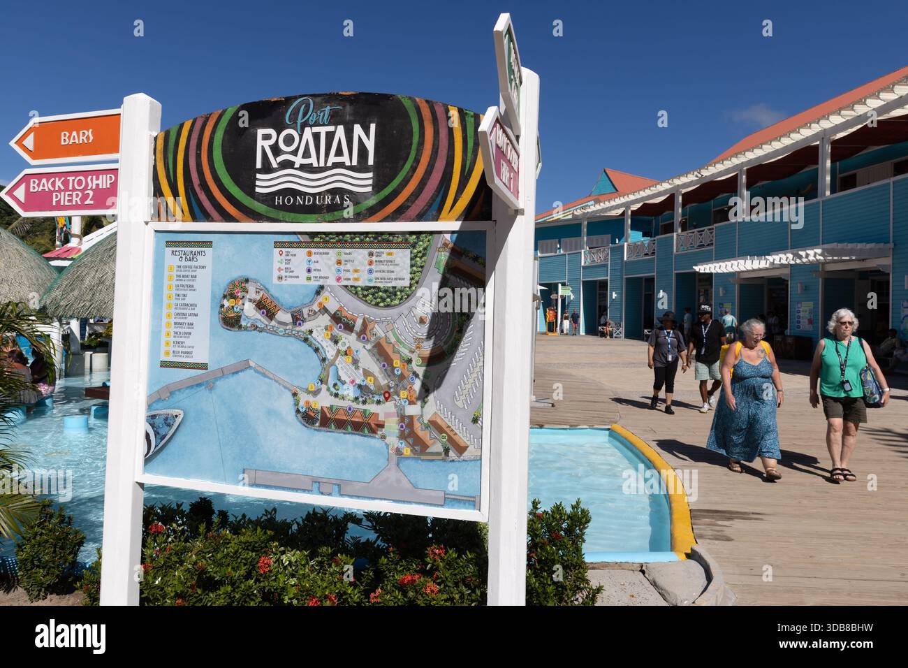 Port Roatan Map Key Passengers walk past a Port Roatan map and signage after disembarking ...