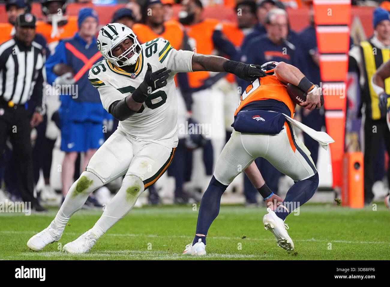 Green Bay Packers defensive end Colby Wooden, left, tries to sack ...