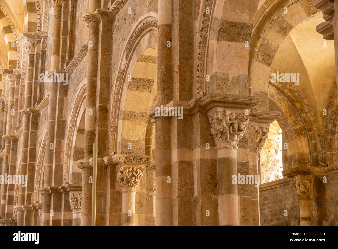 Historic stone columns with carved capitals and arches in a sacred ...