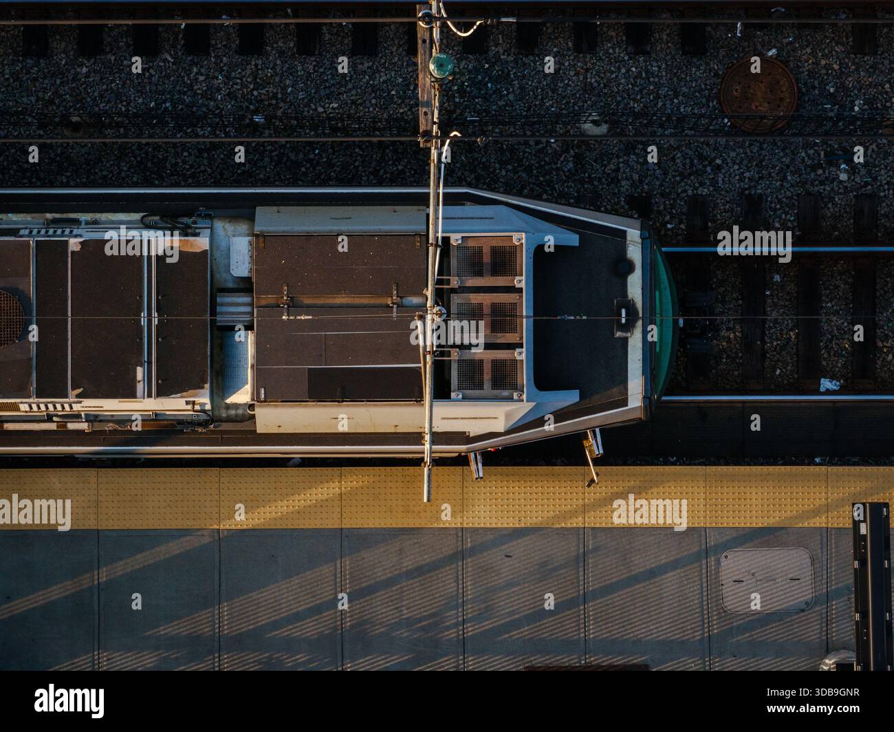 Aerial view of the train, its silver body gleaming under the sunlight ...
