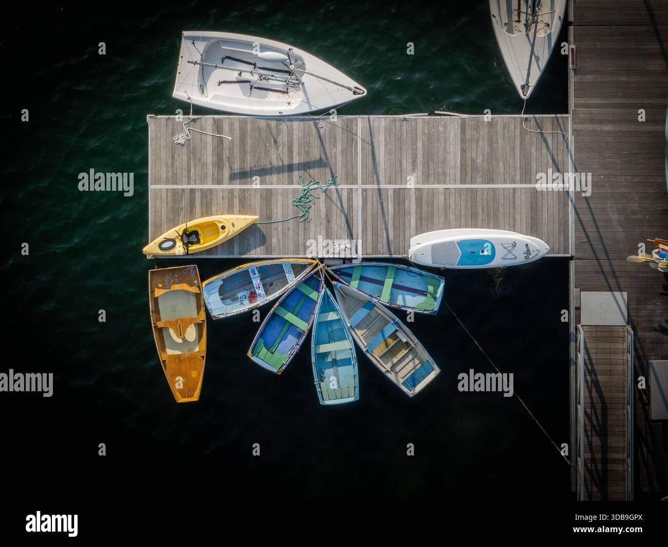 Assachu Aerial view of boats docked on a wooden pier, a colorful array against ...