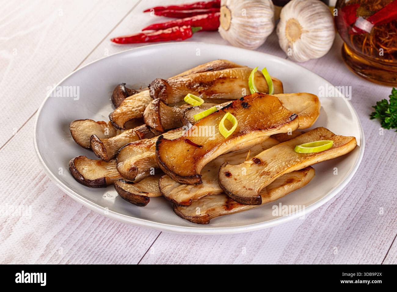 Vegan cuisine - Roasted eringi mushrooms in the plate Stock Photo - Alamy