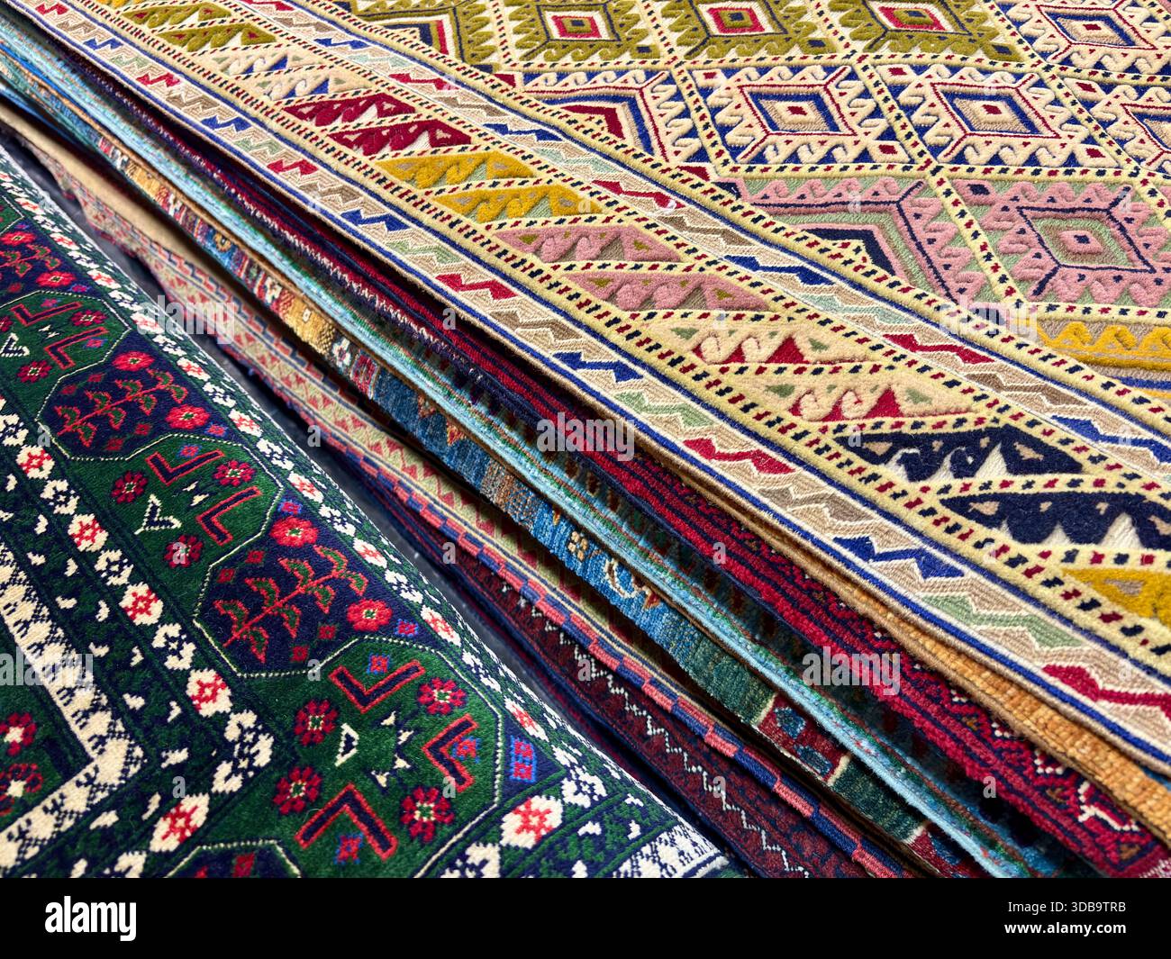 Vibrant geometric patterns on Central Asian folded carpets. Stock Photo