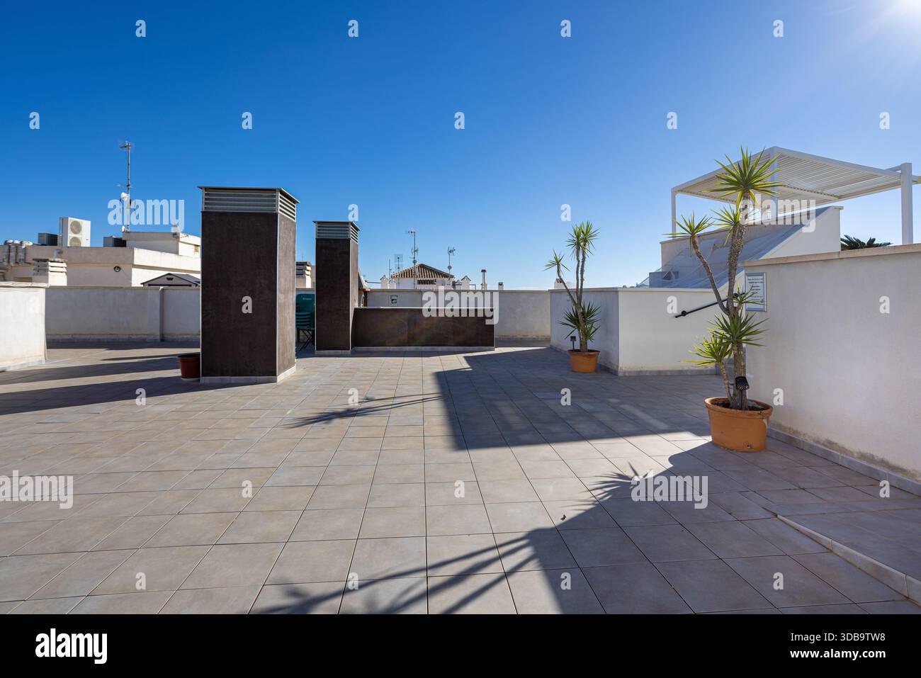Spacious Rooftop Spacious rooftop area with clear sky, planters, and architectural ...