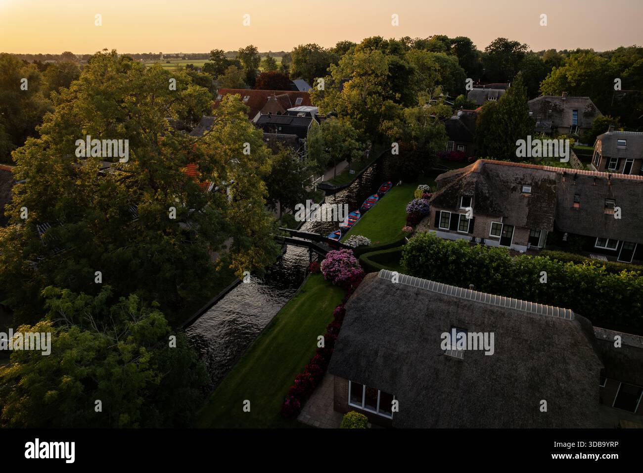 Aerial view of quaint thatched-roof houses nestled amongst lush ...