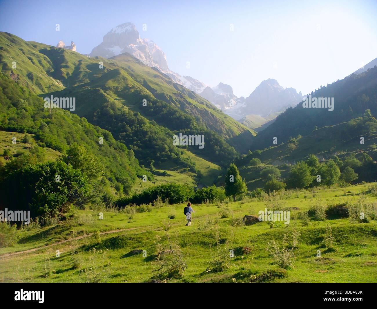 Scenic mountain landscape with a trekker exploring the Upper Svaneti region. - Stock Image