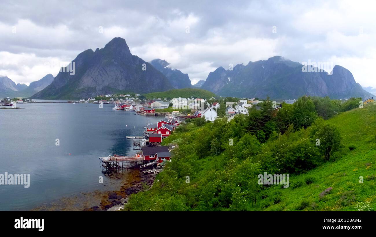 Panoramic view of the fishing village Reine with red cabins and mountains, Lofoten Islands, Norway - Stock Image