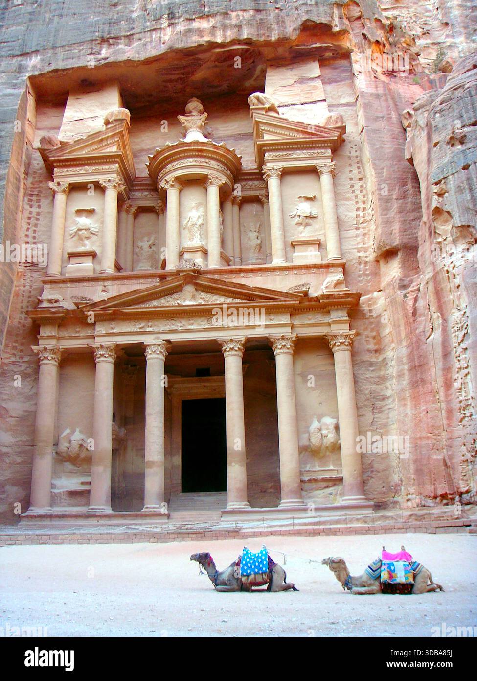 The iconic Treasury (Al-Khazneh) facade carved into the sandstone cliff at the end of the Siq canyon in Petra, Jordan. - Stock Image