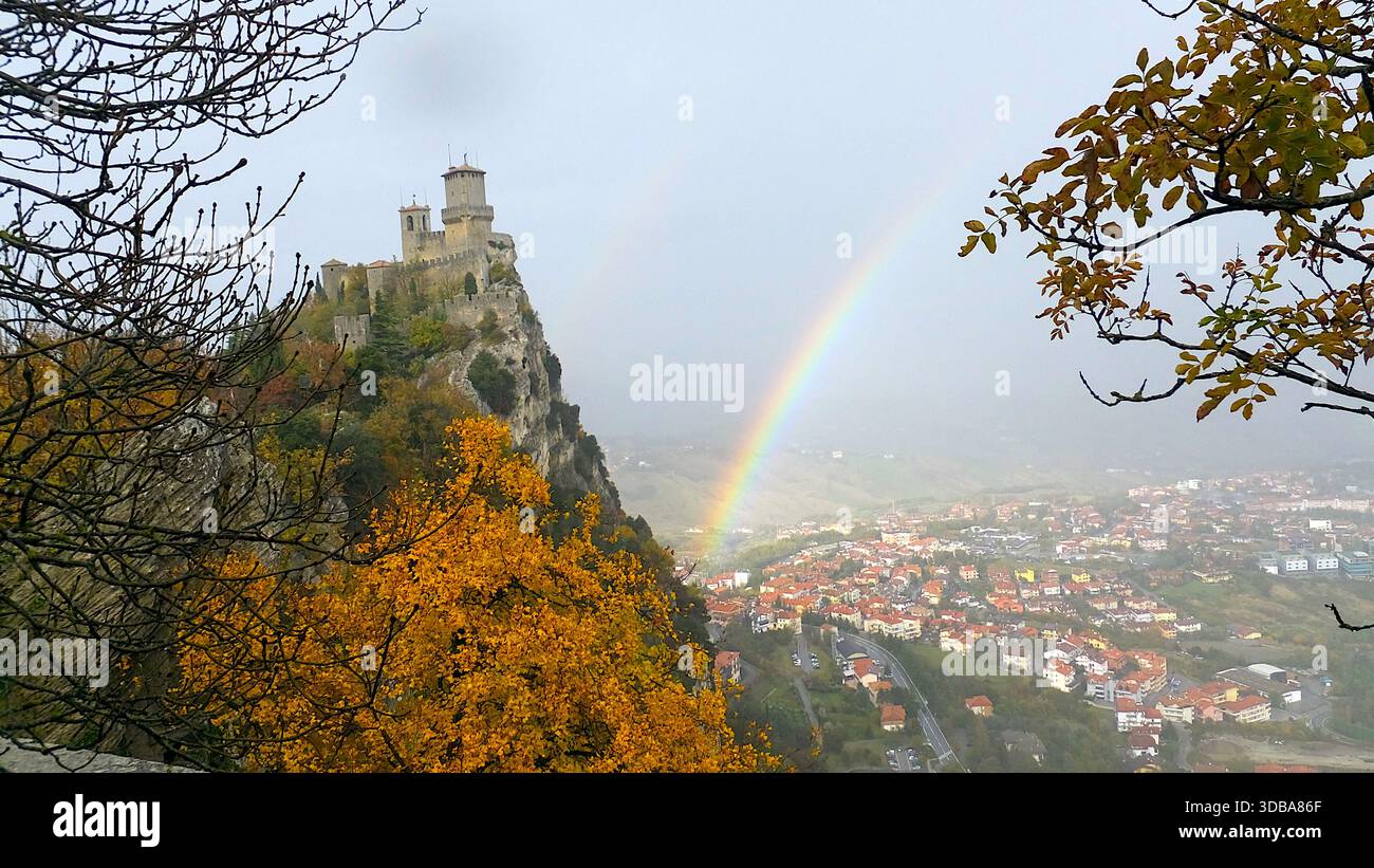 Dramatic autumn landscape of San Marino fortress with a bright rainbow. - Stock Image