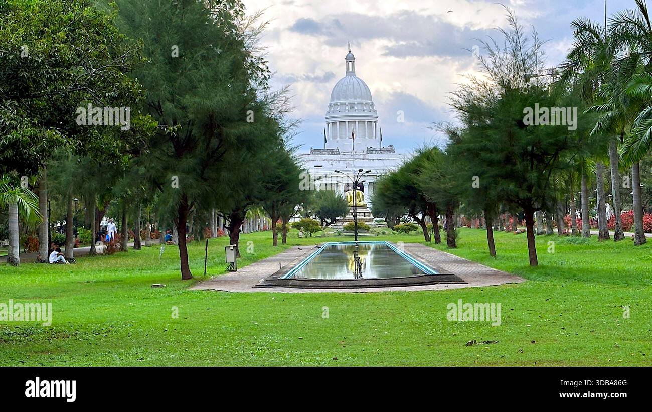 Colonial architecture of Sri Lanka: White municipal building with a large dome and garden landscape. - Stock Image