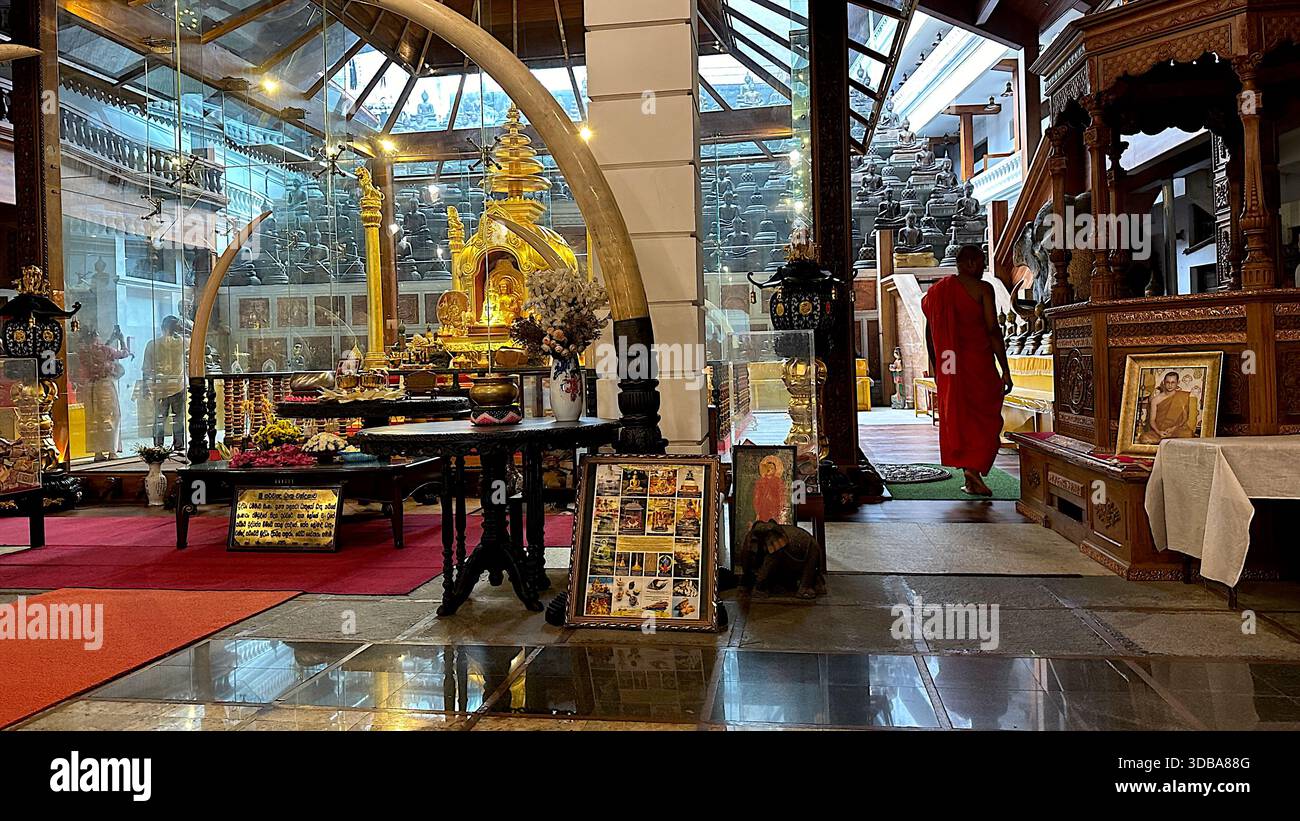 Sacred Golden Relic Chamber framed by large Elephant Tusks inside Gangaramaya Temple, Colombo. - Stock Image