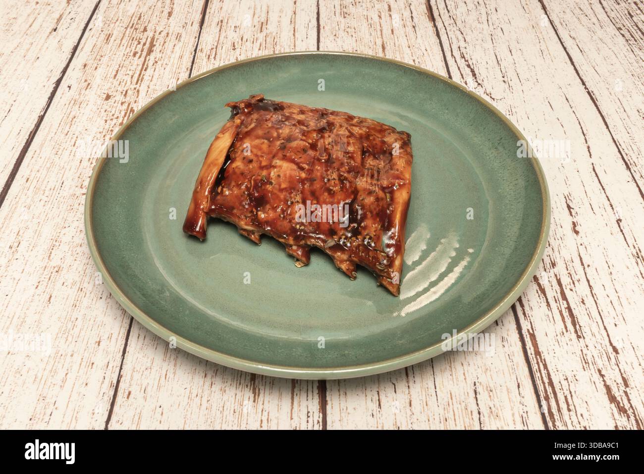 Pork ribs crusted with ground coffee and cocoa, which impart an earthy and smoky flavor, served with mashed potatoes and chives Stock Photo