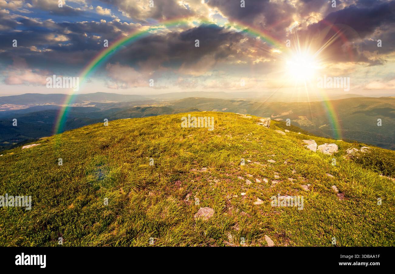 grassy slopes with boulders of mountain at sunset. beautiful summer scenery of alpine green environment under sky with clouds in evening light. timele Stock Photo