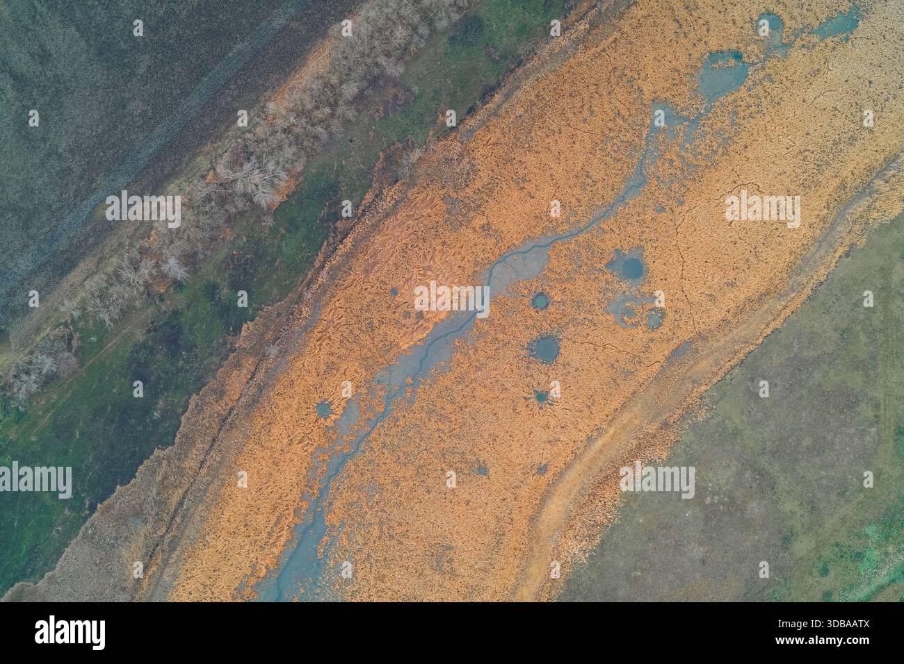 Intersecting Rivers Aerial view of a winding wetland river situated next to earthwork ...