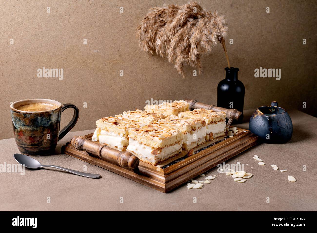 Homemade Norwegian cake Verdens Beste Kake with custard, meringue, and  almonds, cut into squares, served on wooden tray. Beige table with coffee  cup Stock Photo - Alamy, image size:1300x956