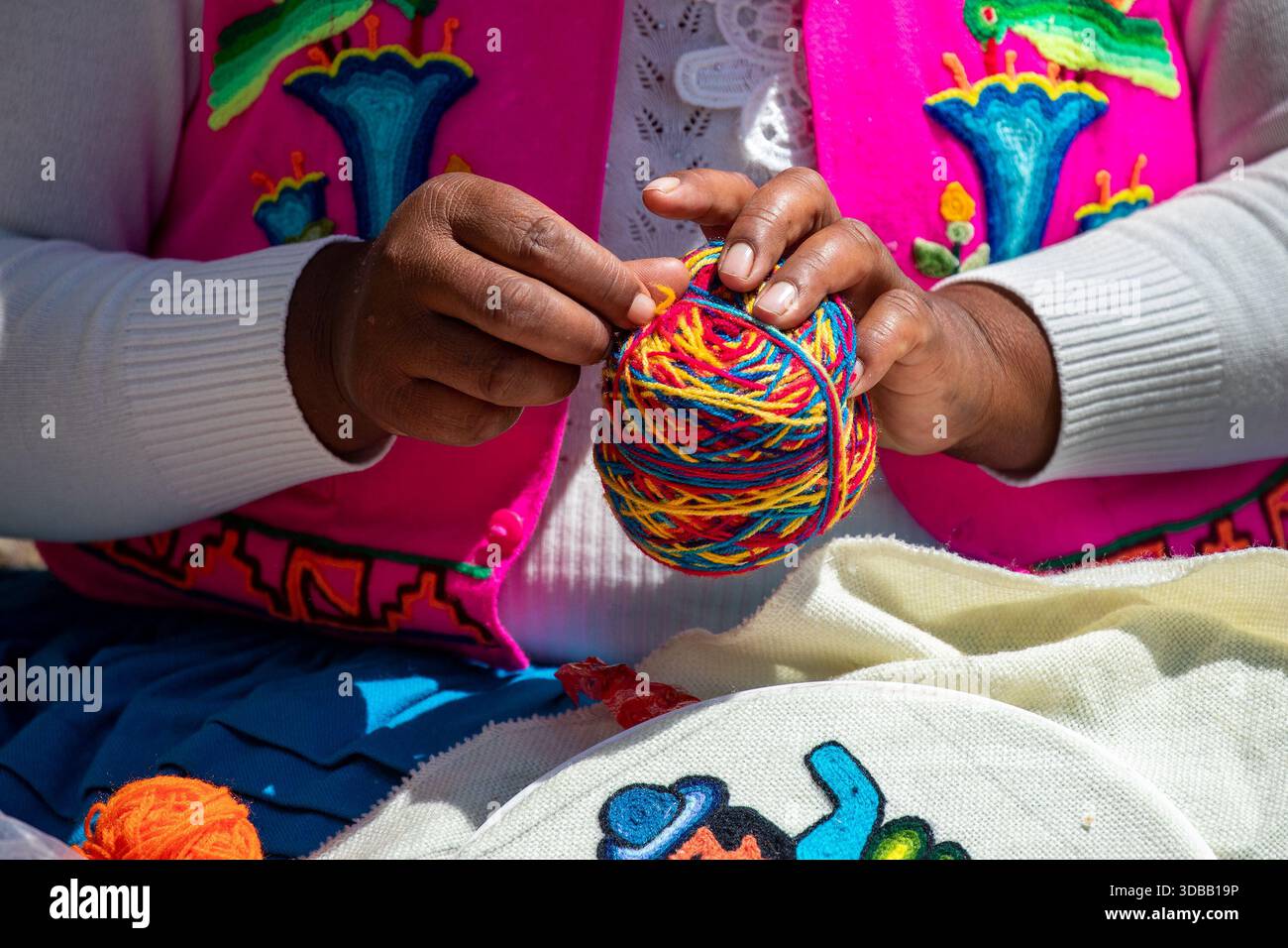 skillful Uros hands at work, delicately embroidering traditional Andean ...