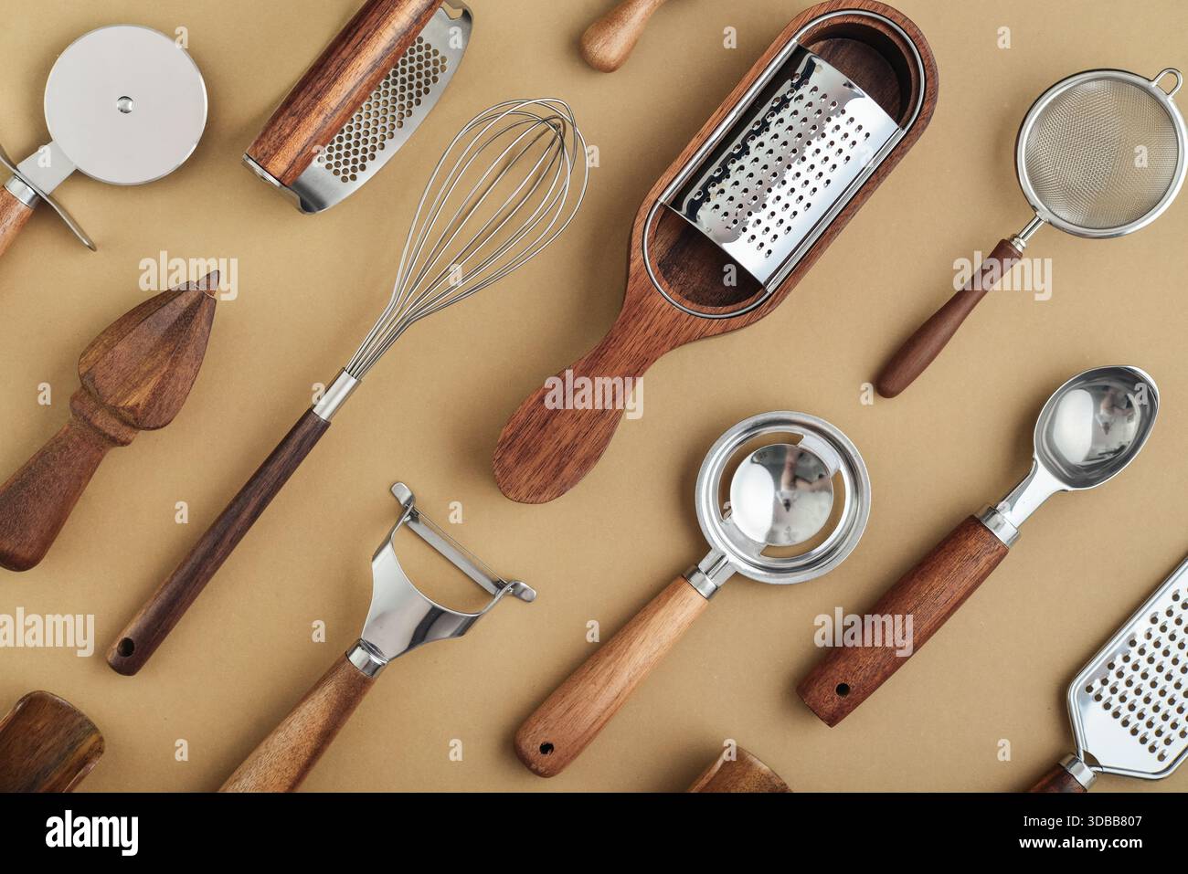 Various kitchen utensils or cooking tools on brown background, top view, flat lay. Stock Photo